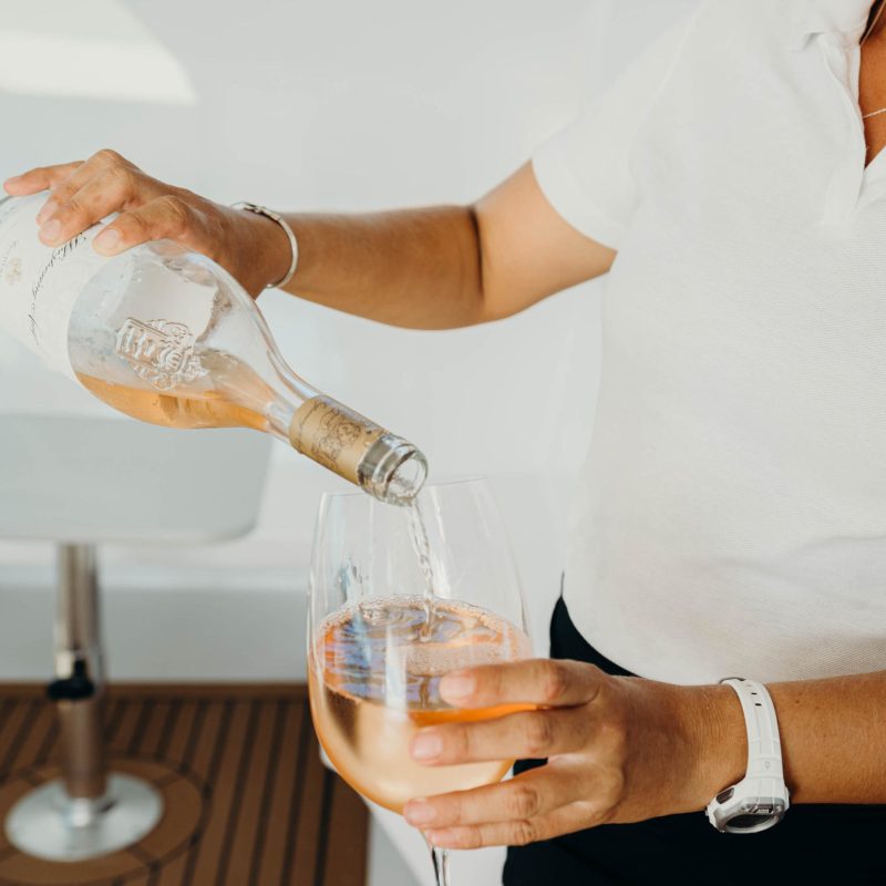 a hand holding a glass of wine