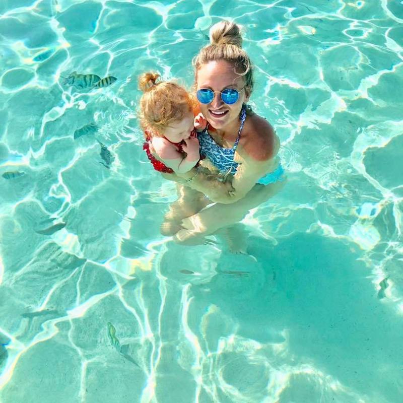 a teddy bear is swimming in the water