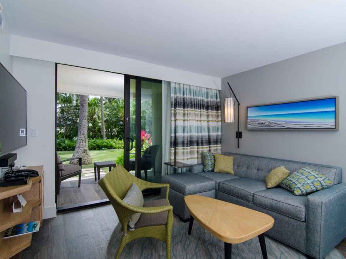 a living room filled with furniture and a large window