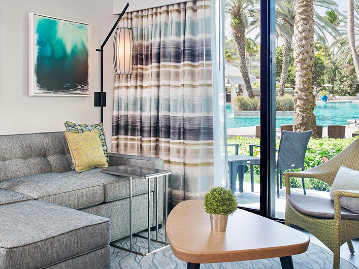 a living room filled with furniture and a large window