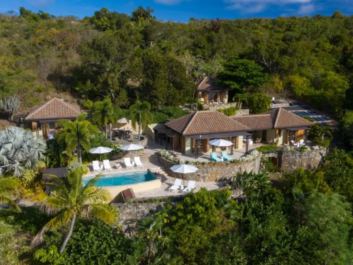 a house with bushes in the background