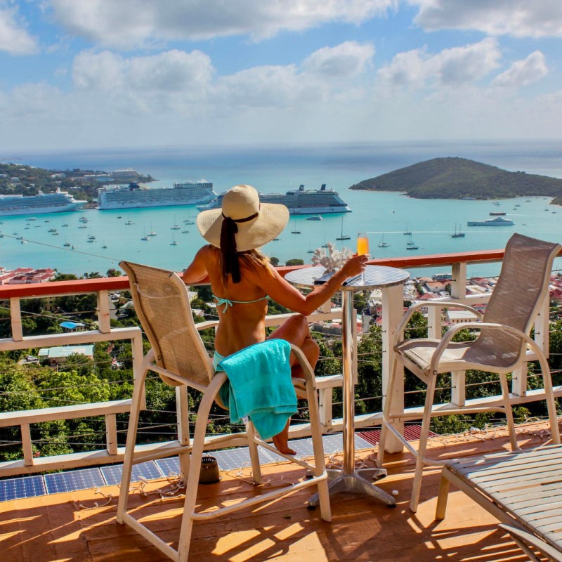 a group of lawn chairs sitting on top of a sandy beach