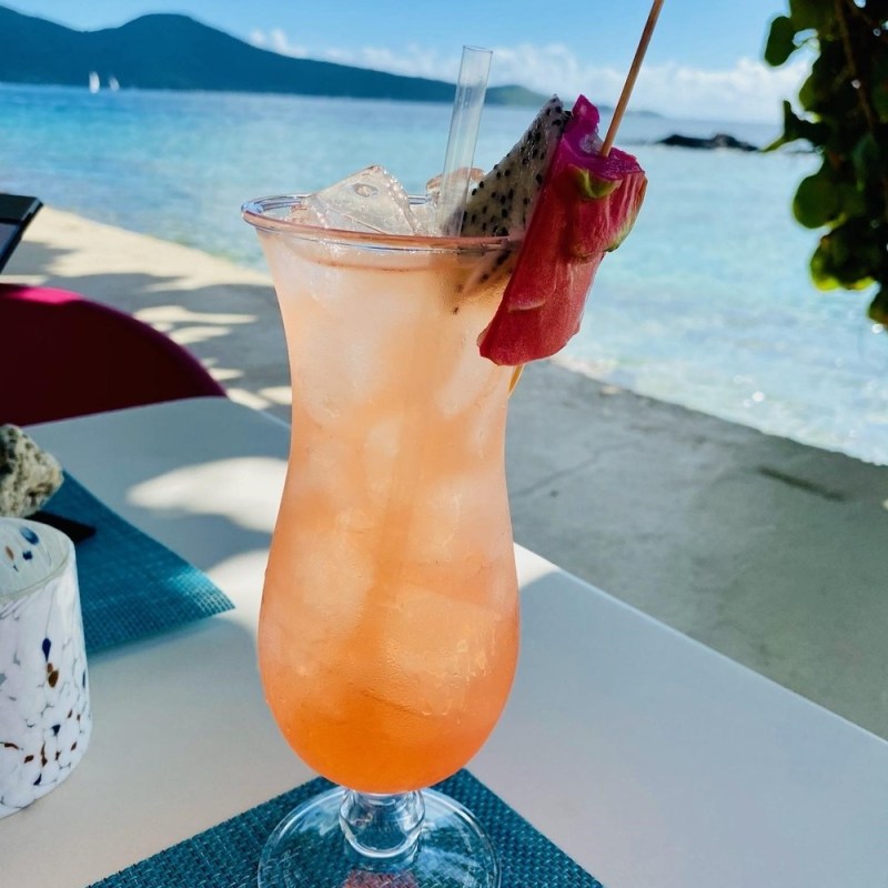 a glass with a blue vase on a table
