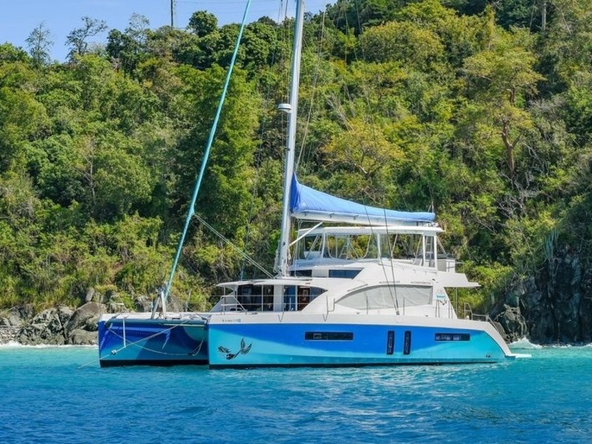 a blue and white boat floating on a body of water