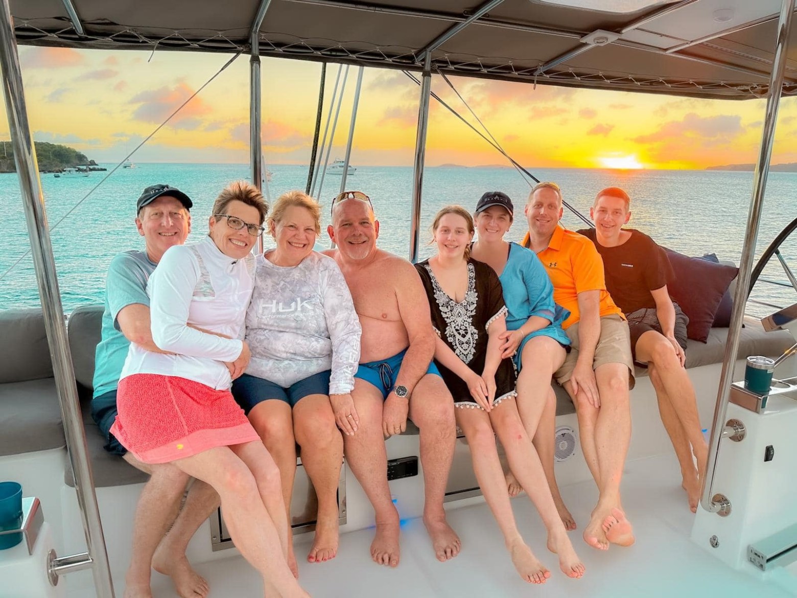 a group of people on a boat posing for the camera