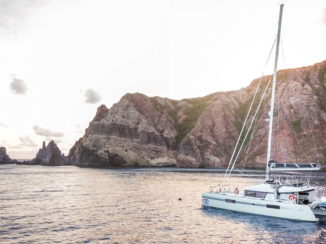 a small boat in a body of water with a mountain in the background