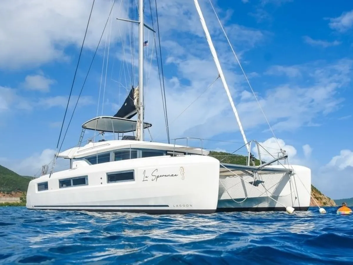 a blue and white boat sitting next to a body of water