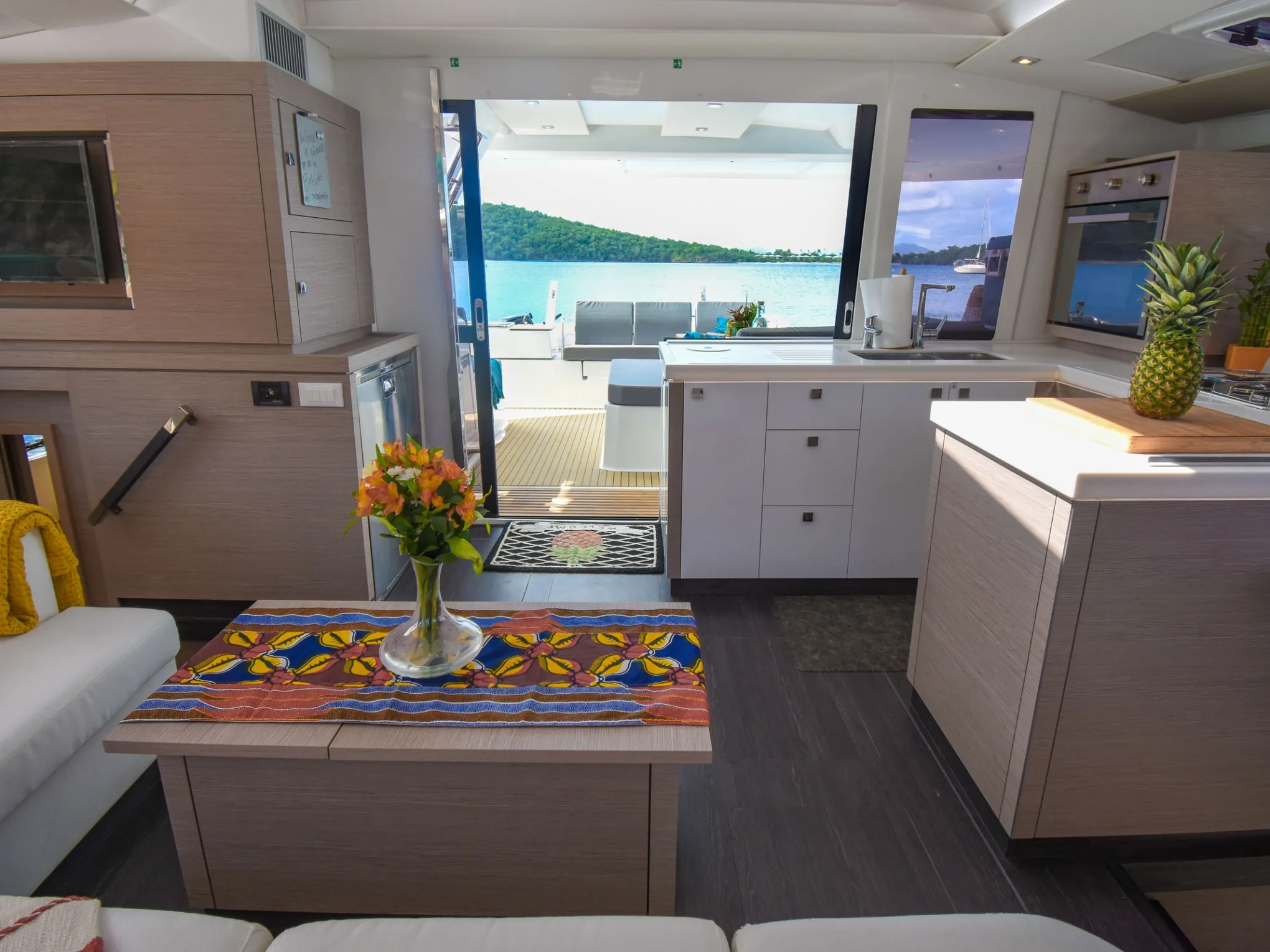 a room filled with furniture and vase of flowers on a table