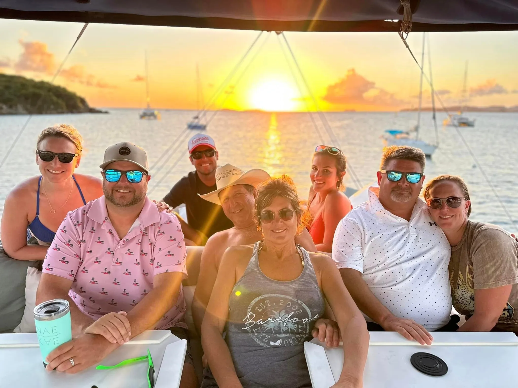 a group of people sitting on a boat posing for the camera