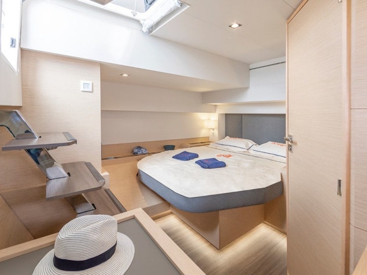 a bedroom with a bed and desk in a room