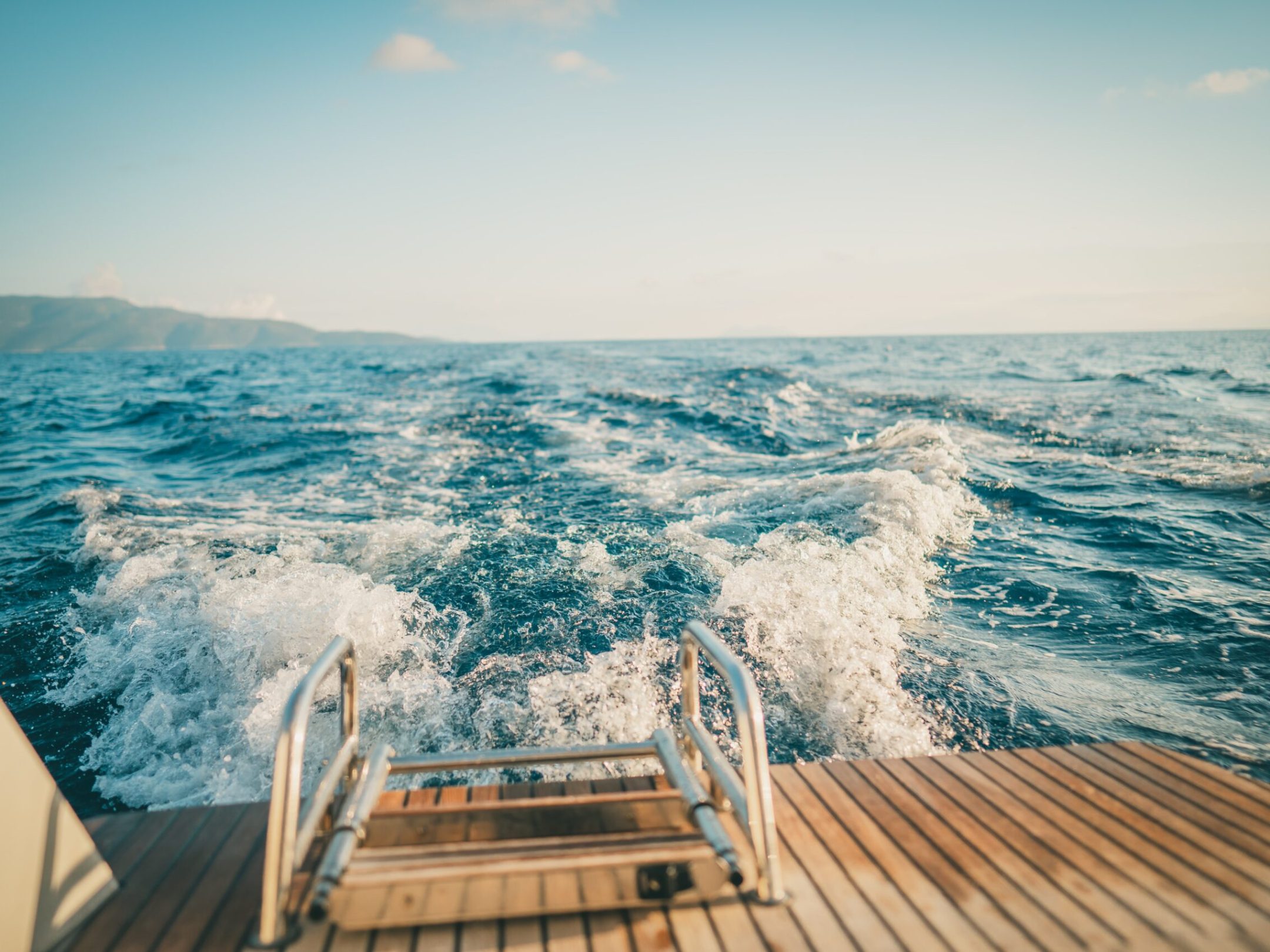 a wooden bench sitting next to a body of water