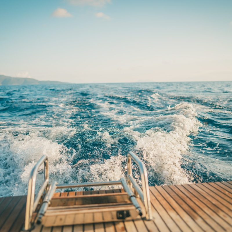a wooden bench sitting next to a body of water