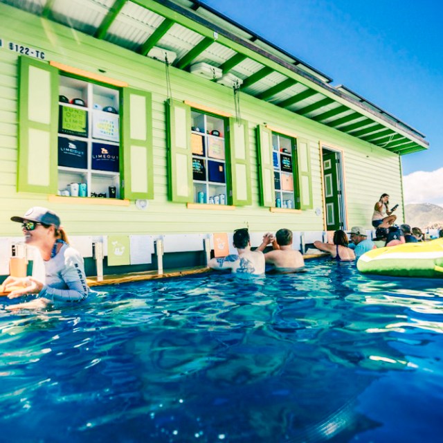 a group of people swimming in a pool of water