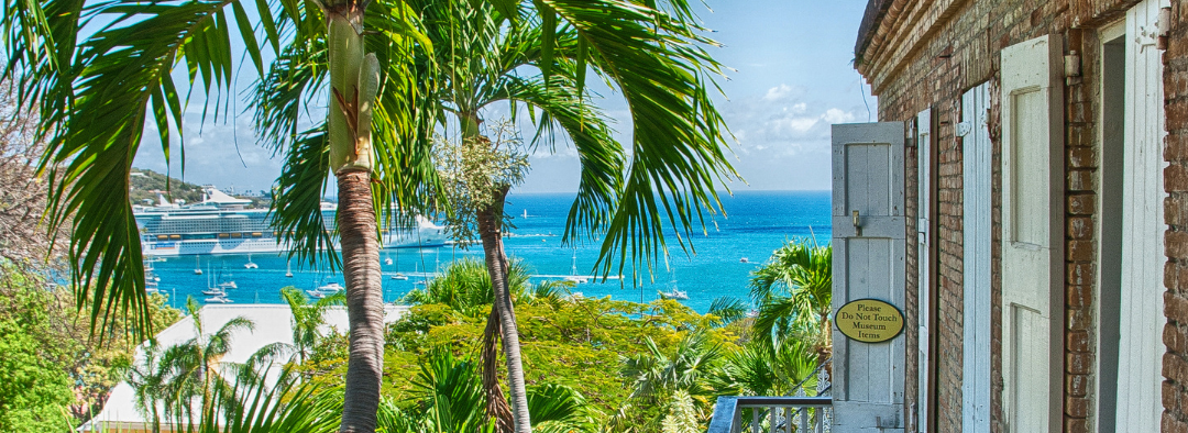Social Media Posts for Caribbean Concierge (2) a building next to a palm tree