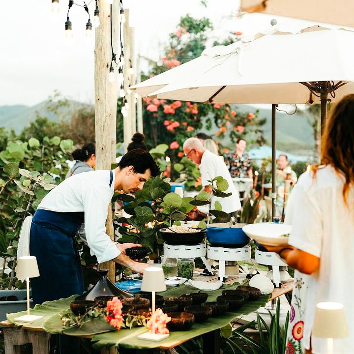 a person standing in a kitchen preparing food