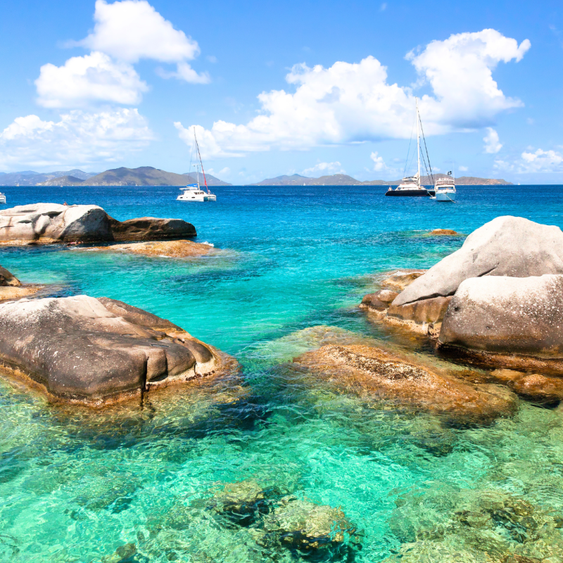 a blue and white boat sitting next to a body of water