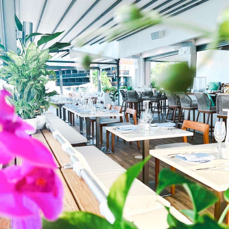 a room filled with furniture and vase of flowers on a table