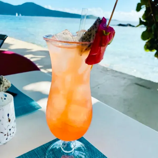 a glass with a blue vase on a table