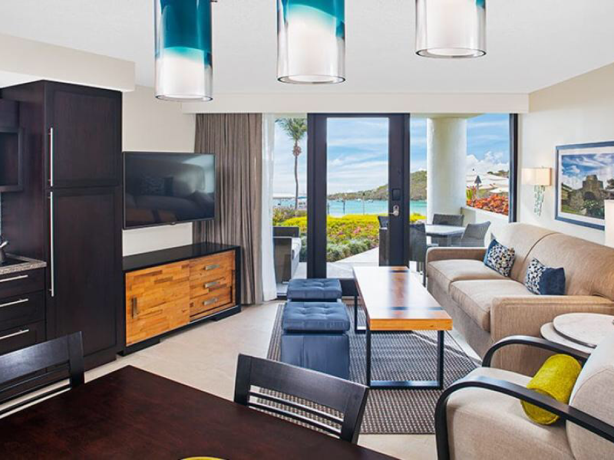 a living room filled with furniture and a large window