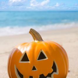 a lamp that is on top of a sandy beach
