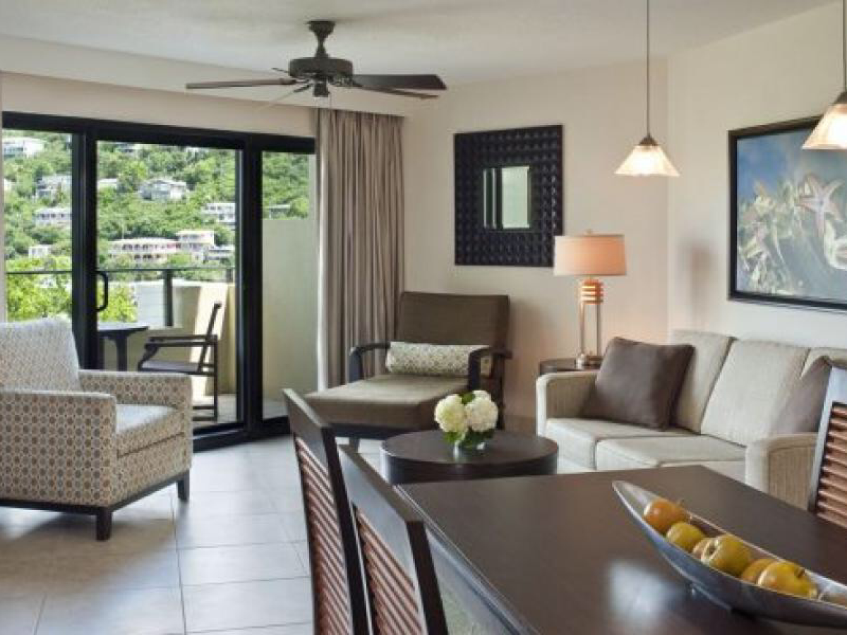 a living room filled with furniture and a large window