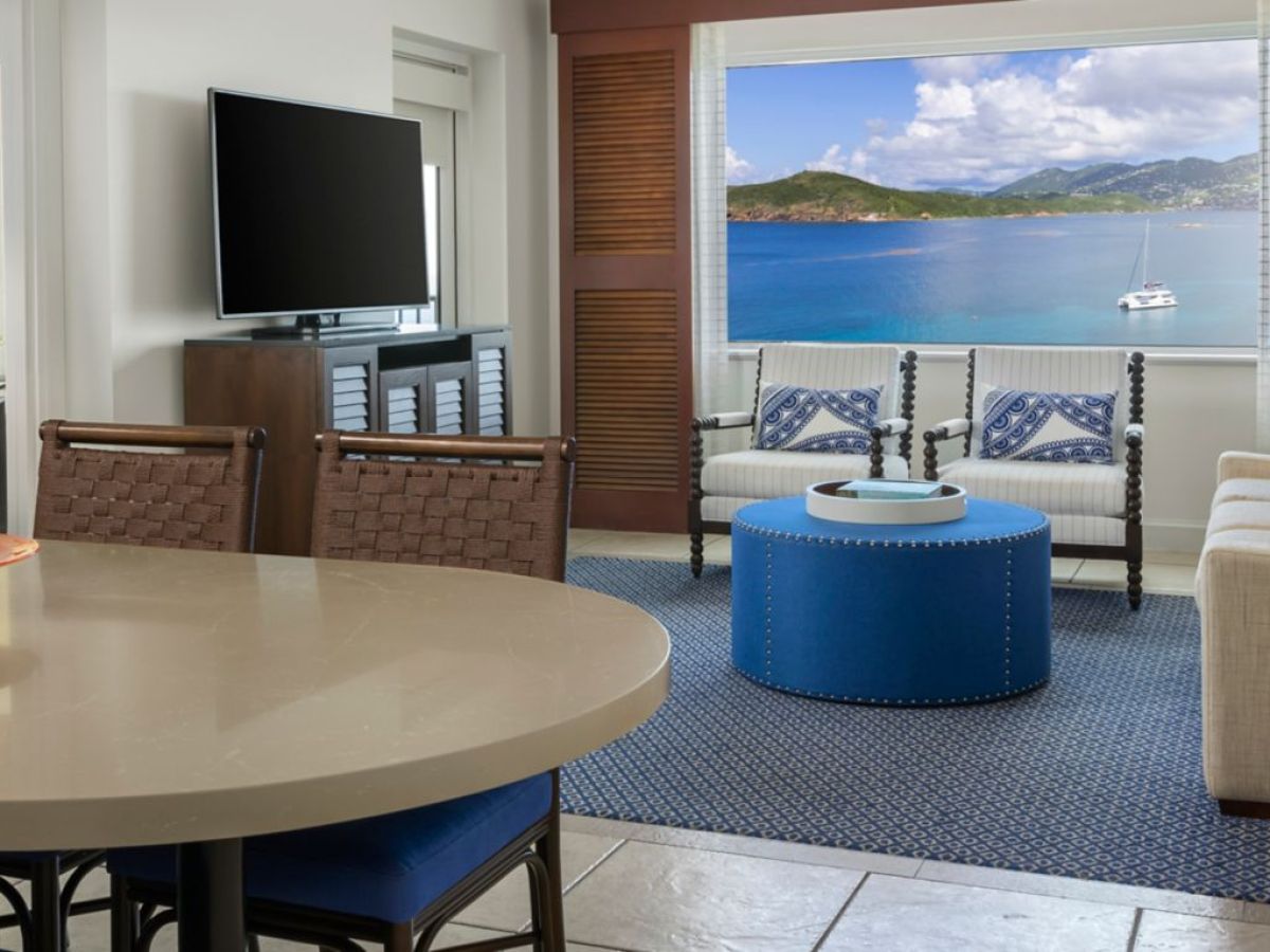 a hotel room with a blue chair