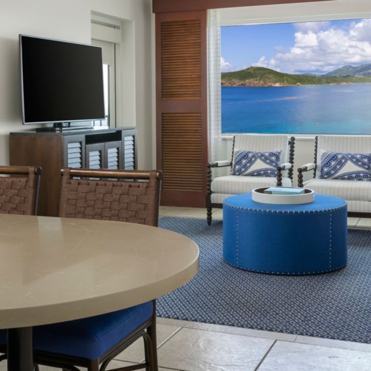 a hotel room with a blue chair