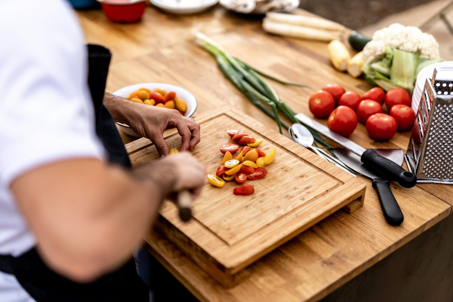 a group of people sitting on top of a wooden cutting board