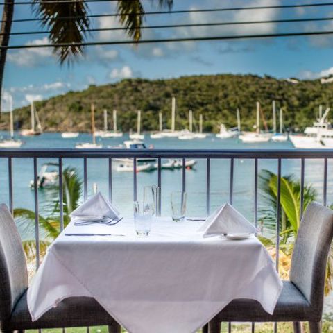 a dining room table in front of a fence