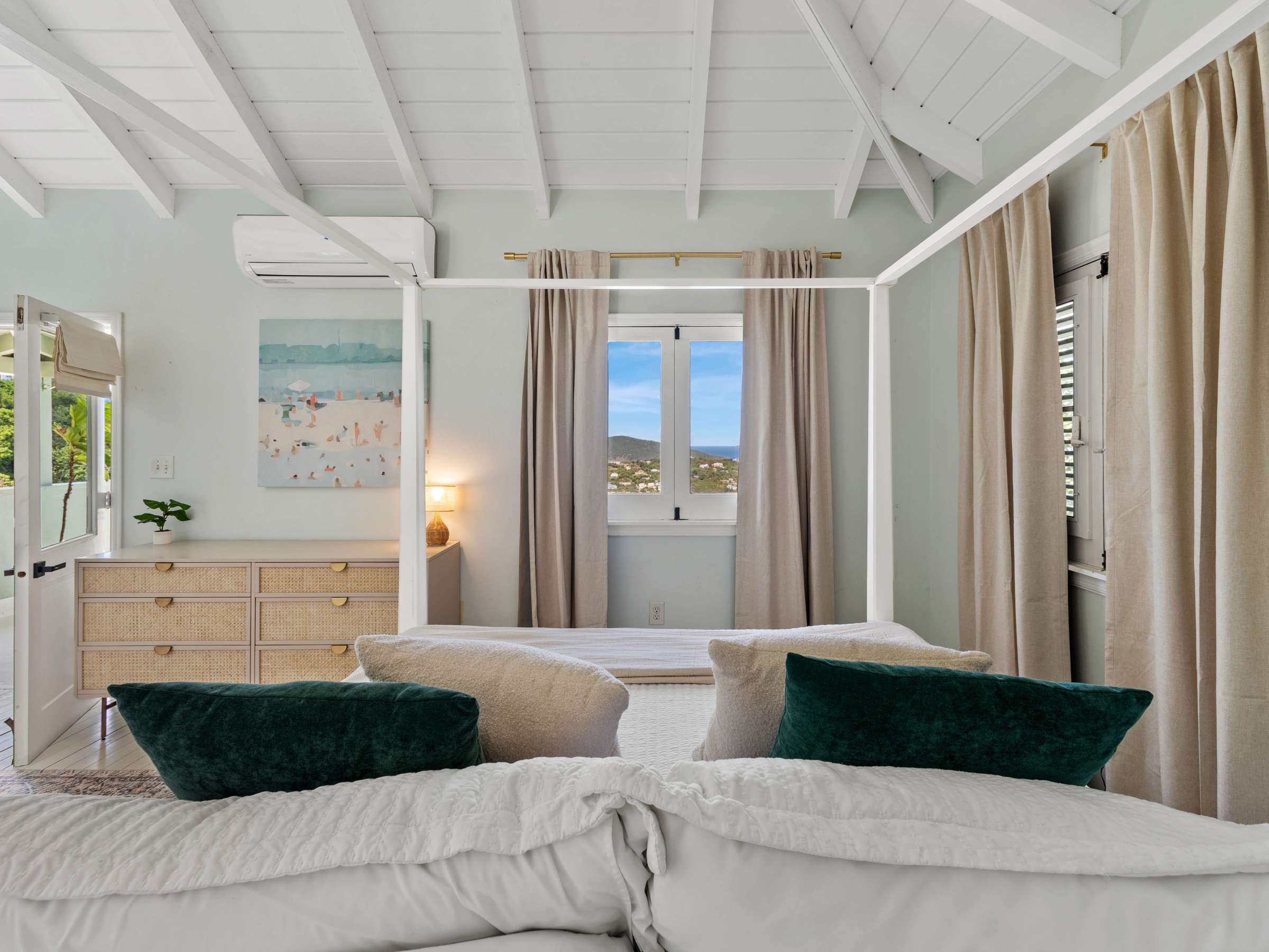 a bedroom with a bed and a large window