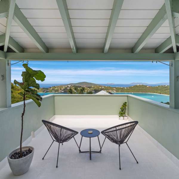 a couple of lawn chairs sitting on top of a building